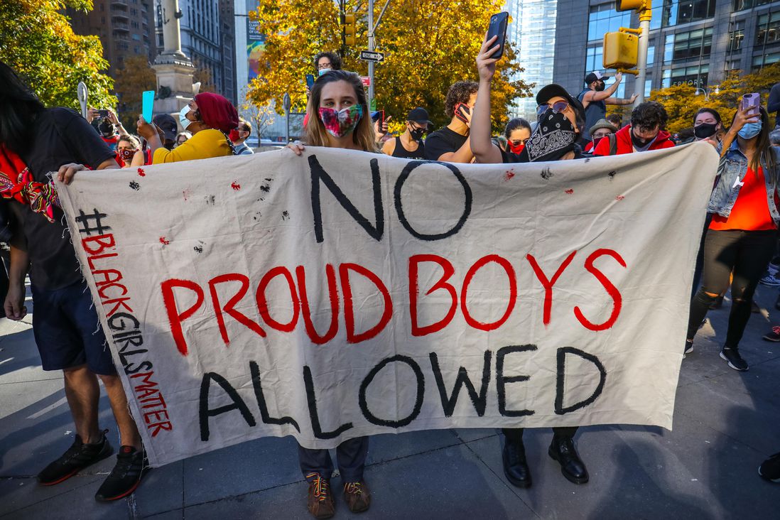 A marcher holds a "No Proud Boys Allowed" sign